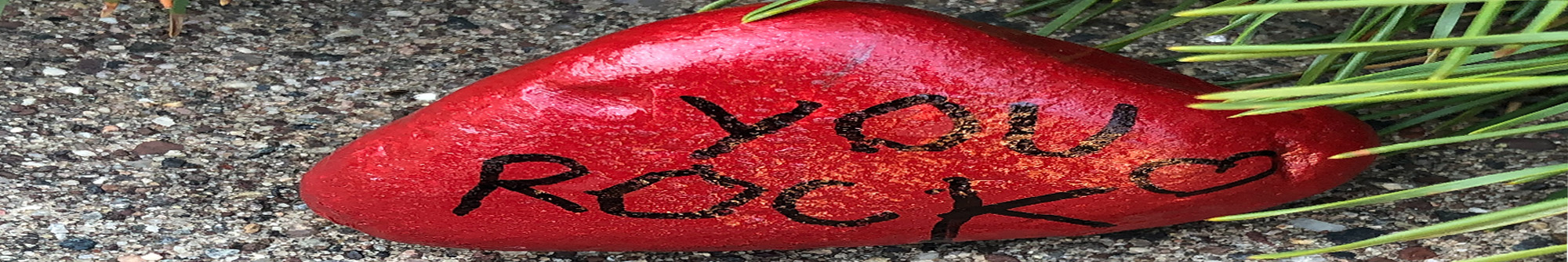 Rock painted red with You Rock and a heart painted in black