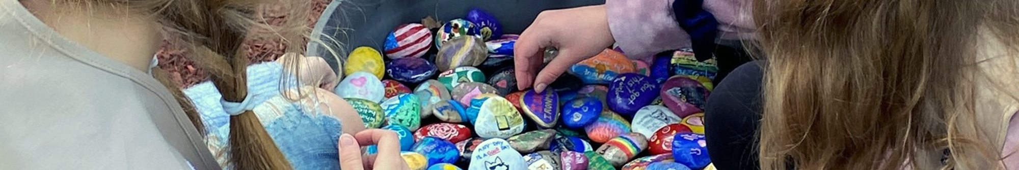 SRS girl scouts painting rocks in honor of Veterans Day