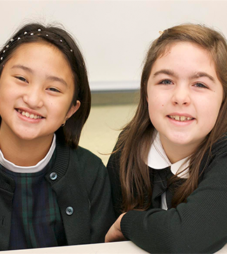 Two smiling students pose together