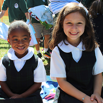 Two smiling students enjoying an outside activity