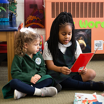 Two young students reading together