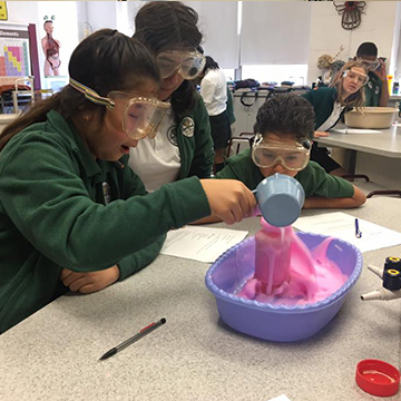 Three curious students enjoying a fun science project