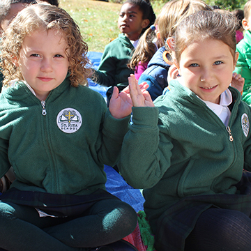 Two young happy students enjoying an outside activity 