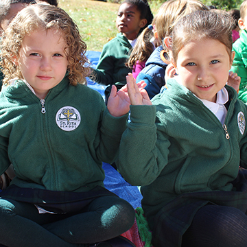 Two young smiling students pose together