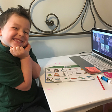 Happy young St. Rita student working on homework