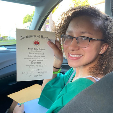 Happy middle school student holding up certificate